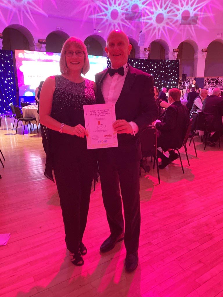 Alan Adams and his partner Carolyn holding the award