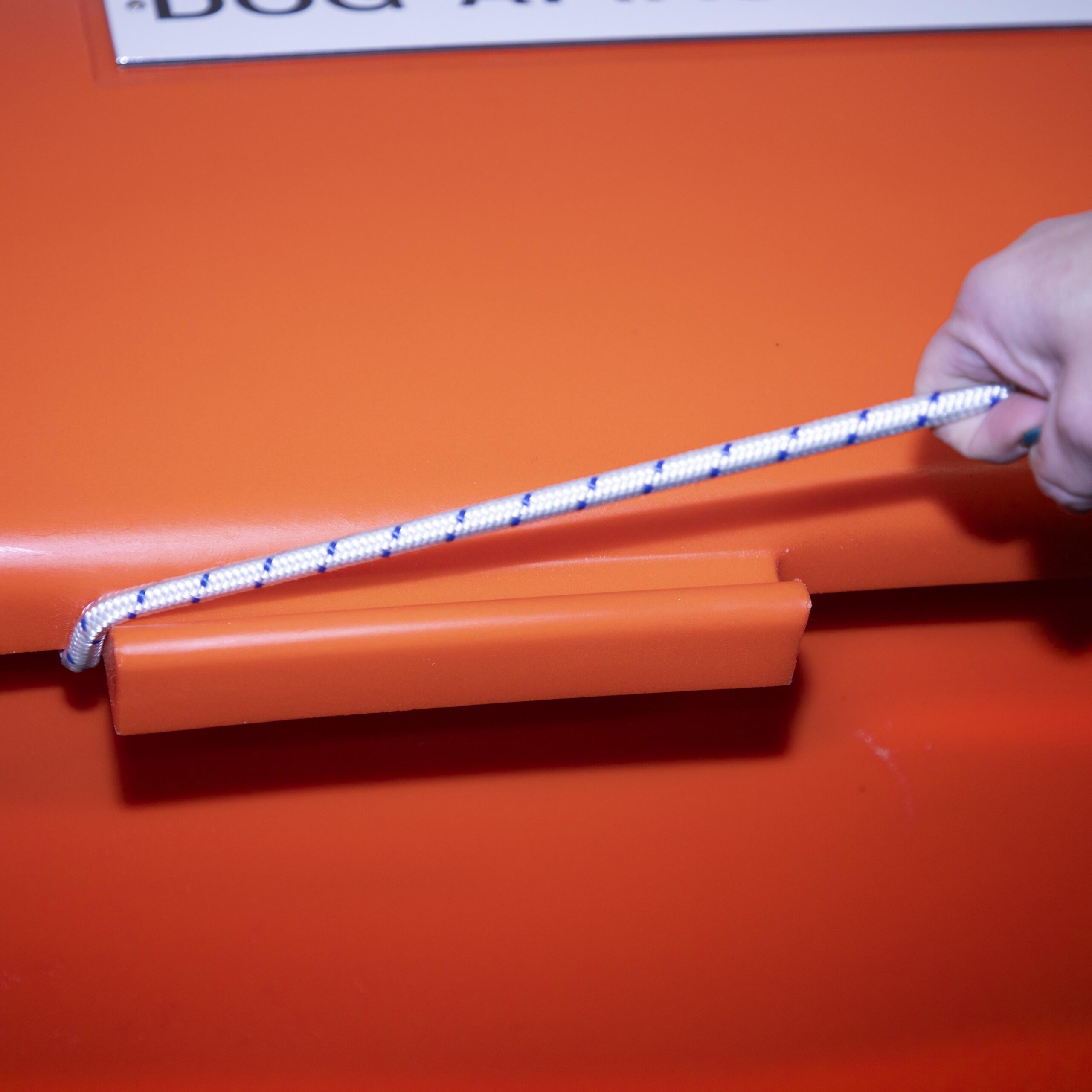 Unhooking the bungee cord lid release easily with only one hand